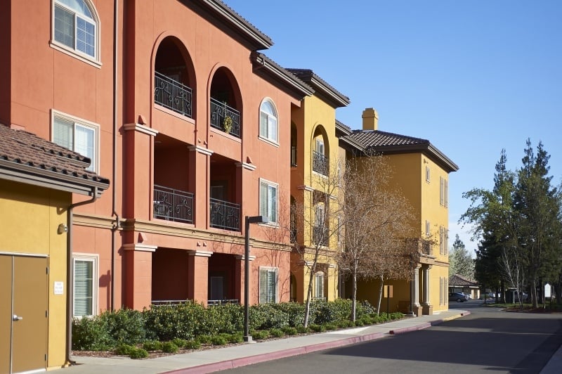 Colorful orange and yellow exterior of apartment buildings